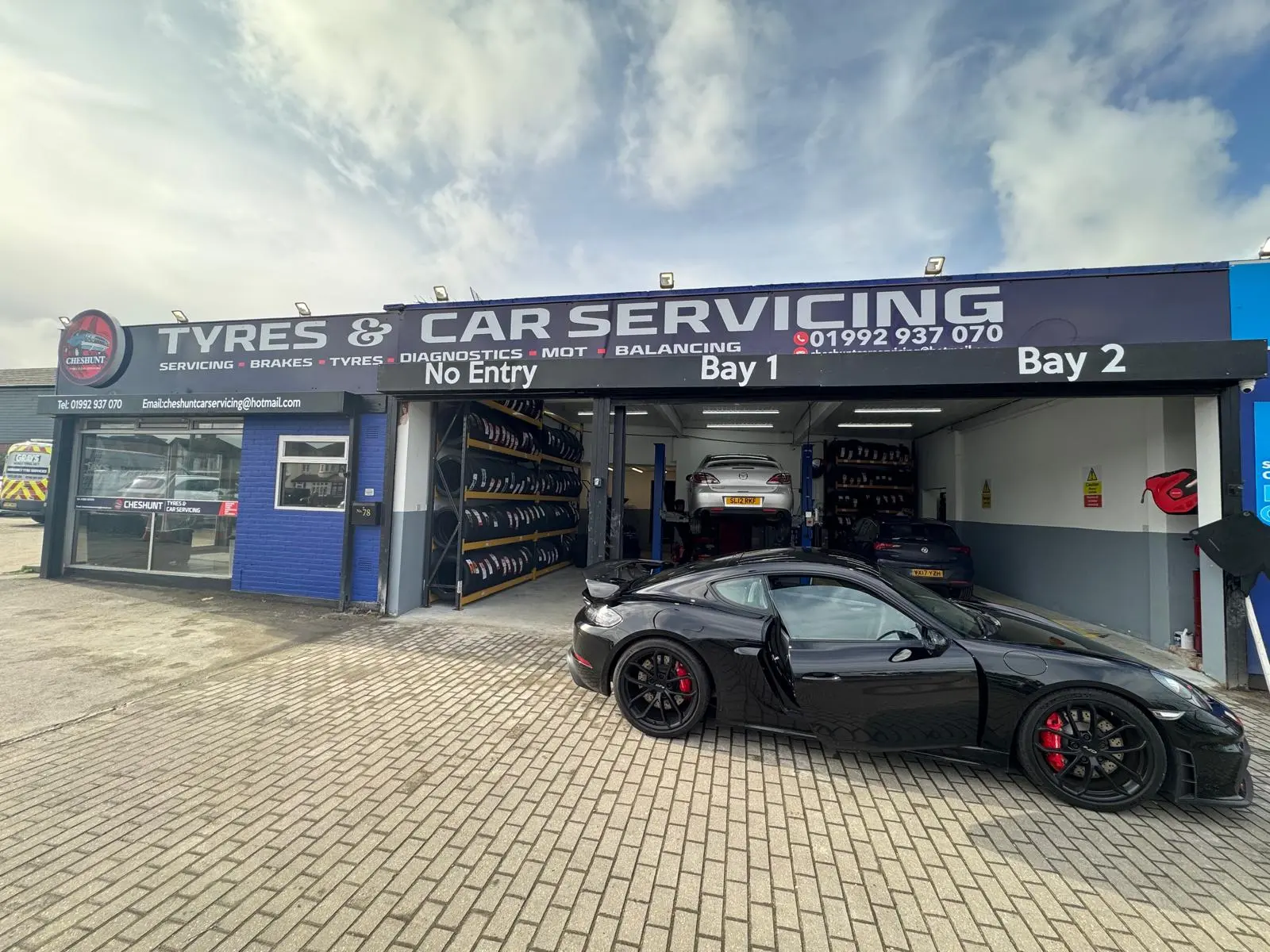 Cheshunt Tyres & Car Servicing garage frontage with two open bays